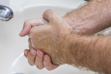 Fototapeta premium Man washing hands in basin close-up