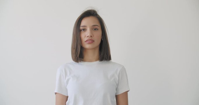 Young woman open eyes on white background