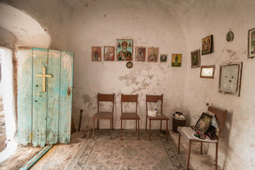 interior of small church with hanging green painted door on Kythira, Greece