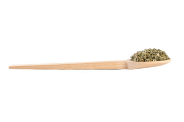 dried artichoke leaves or in latin Cynarae folium in wooden spoon isolated on white background....