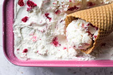 Waffel cornet filled with homemade Ice cream  made with Greek yogurt and raspberry. Summer refreshment and healthy dessert. Recipe ideas. Close up