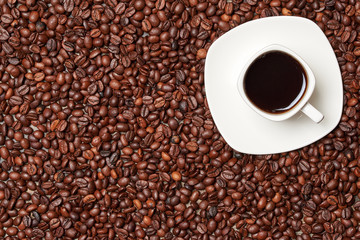 Cup of espresso coffee on a background of coffee beans. View from above. ?opy space