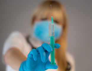 Doctor with syringe in hand.