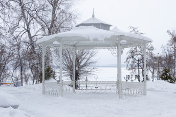 Vintage gazebo in the winter park near river Volga