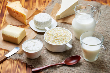 Milk, sour cream, cheese, butter lie on the table