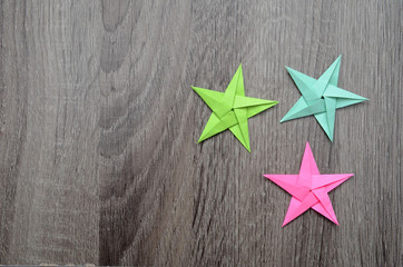 Fototapeta na wymiar Colorful origami lucky stars on wooden background