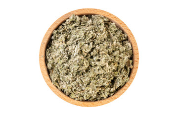 dried artichoke leaves or in latin Cynarae folium in wooden bowl isolated on white background. medicinal healing herbs. herbal medicine. alternative medicine