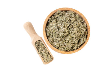 dried artichoke leaves or in latin Cynarae folium in wooden bowl and scoop isolated on white background. medicinal healing herbs. herbal medicine. alternative medicine