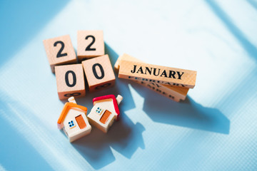 Miniature house with wooden month and 2020 characters using as business and property real estate...