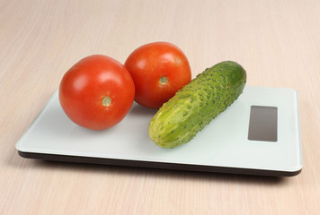 Big red apple on a kitchen scale on white background