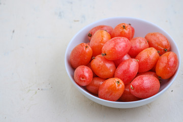 Elaeagnus berry in white bowl on backdrop,copy space,fruit of thailand