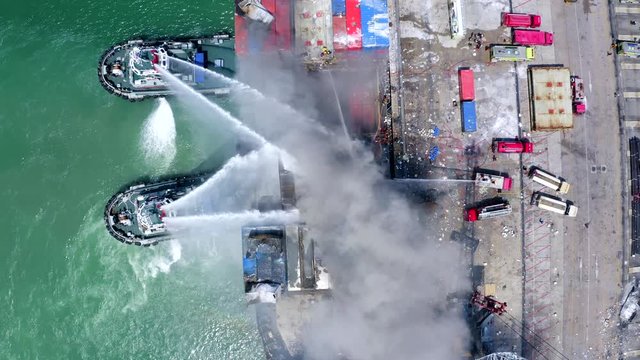A burning fire boat Products Fire fighter during cargo fire accident at the port