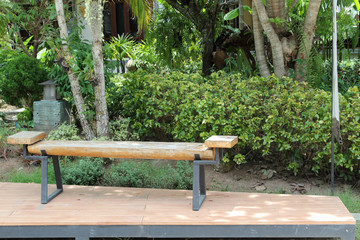 Wooden bench on wooden floor in the park.