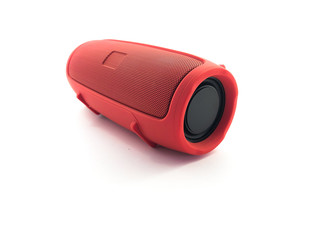 Portable speaker isolated on a white background. Red musical bluetooth speaker for travel. 