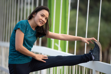 Asian women warm up before exercising in the park.