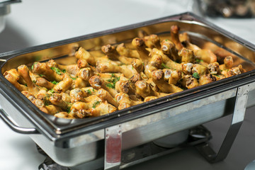 Baked chicken drumsticks on a baking tray
