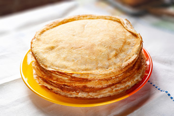A stack of pancakes. Thin pancakes on a plate. Traditional food.