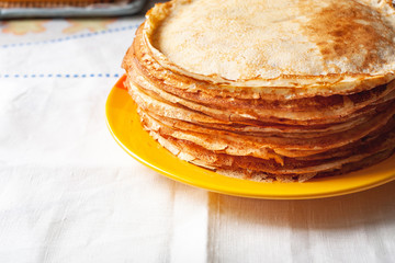 A stack of pancakes. Fragment thin pancakes on a plate. Traditional rustic food.