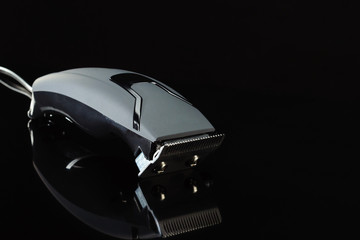 black hair barber clippers, haircut on black background