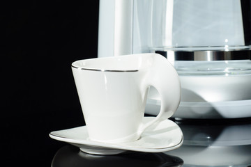 Cup near Espresso coffee machine on the black background