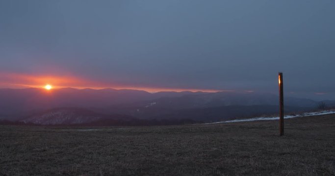 Wide Angle Time Lapse With Slow Push In On Sunrise View From On Top Of Max Patch In NC. Dark Clouds Sweep Across The Sky Overhead.