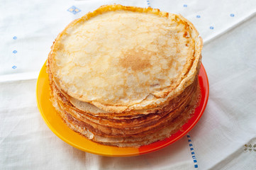 A stack of pancakes. Thin fragrant pancakes in a plate. Traditional rustic food.