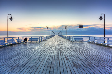 Fototapeta premium Beautiful landscape with wooden pier in Gdynia Orlowo at sunrise, Poland