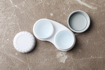 Case for contact lenses on grey background, top view