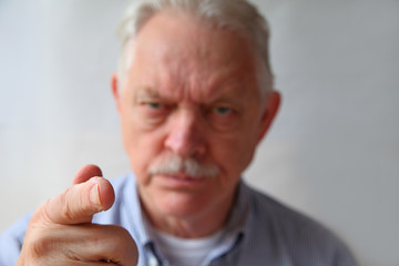Finger-pointing senior man