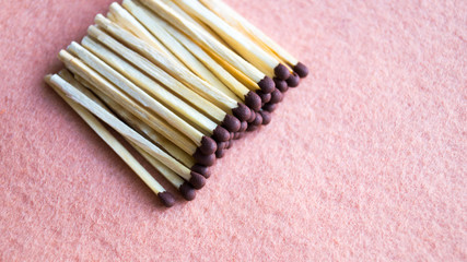 A bunch of matches on a beige background. View from above. Close-up shot. The concept of mining fire, wood, hiking.