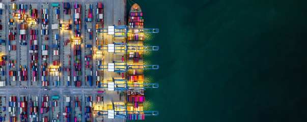 Container ship loading and unloading in deep sea port, Aerial view of business logistic import and export freight transportation by container ship in open sea, Container loading Cargo freight ship.