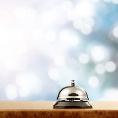 Vintage hotel reception service bell on the desk.