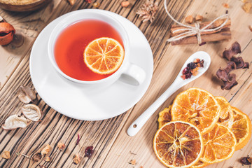 Fruit tea cup with cinnamon dried orange and berries, teacup