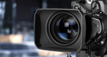 A professional video camera on blur background