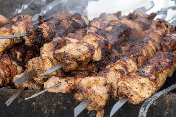 Pieces of fried meat on metal bars. Selective focus.