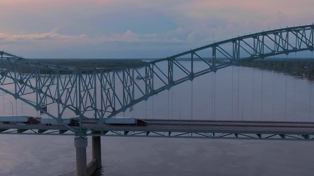 Aerial of traffic on the  Hernando de Soto Bridge crossing the Mississippi River at sunset. The bridge crosses into Arkansas. Memphis, Tennessee, USA