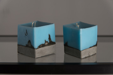 blue candle on a concrete base