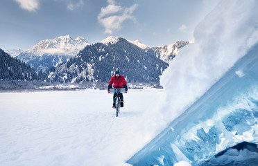 Fototapeta na wymiar Man ride bicycle at frozen lake