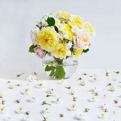 Bouquet of flowers  on white background. Roses on glass round vase, celebration concept