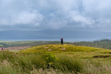 Tourist making photo of scenic Island of Mull landscape. Hebrides, Scotland.