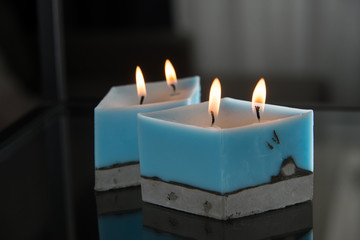 blue candle on a concrete base