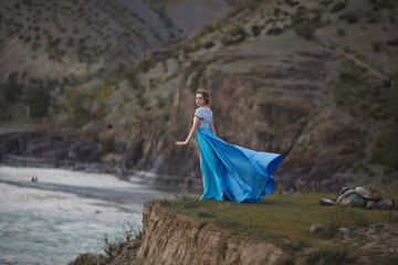 The Tale of the Mermaid. Tale of the River Nymph. Girl in a blue dress by the river.