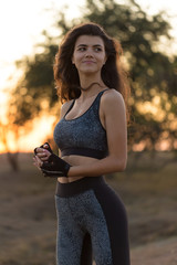 A young slim athletic girl in sportswear with snakeskin prints performs a set of exercises. Fitness...