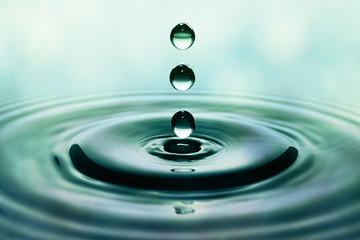 Drops of rain falling on smooth water surface
