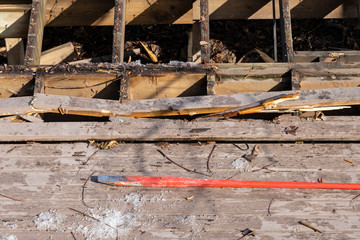 Dismantling an Old Wooden Deck with a Crowbar at a Construction Site