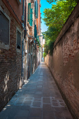 Venice's narrowest street between brick walls, Italy