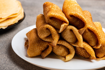 Pancakes with tasty filling on a plate. Close-up.