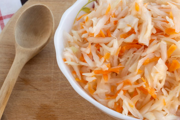Healthy lifestyle dish of sauerkraut salad with carrots in a deep plate