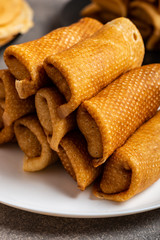 Pancakes with tasty filling on a plate. Food for the holiday Maslenitsa. Macro.