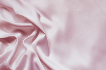Folds of pink satin fabric. Space for text.